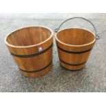 A hardwood bucket, the staves bound by metal strap bands having swing handle; and a similar barrel