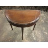 A mahogany turnover top ‘d-shaped’ Edwardian card table, with green baize lining. The moulded top on