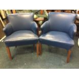 A pair of 1950s leather upholstered tub armchairs, the padded backs with shaped arms above sprung