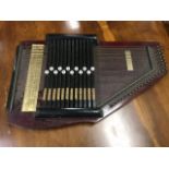 A C20th autoharp, the instrument with 12 keys and 31 strings having stained body with ebonised