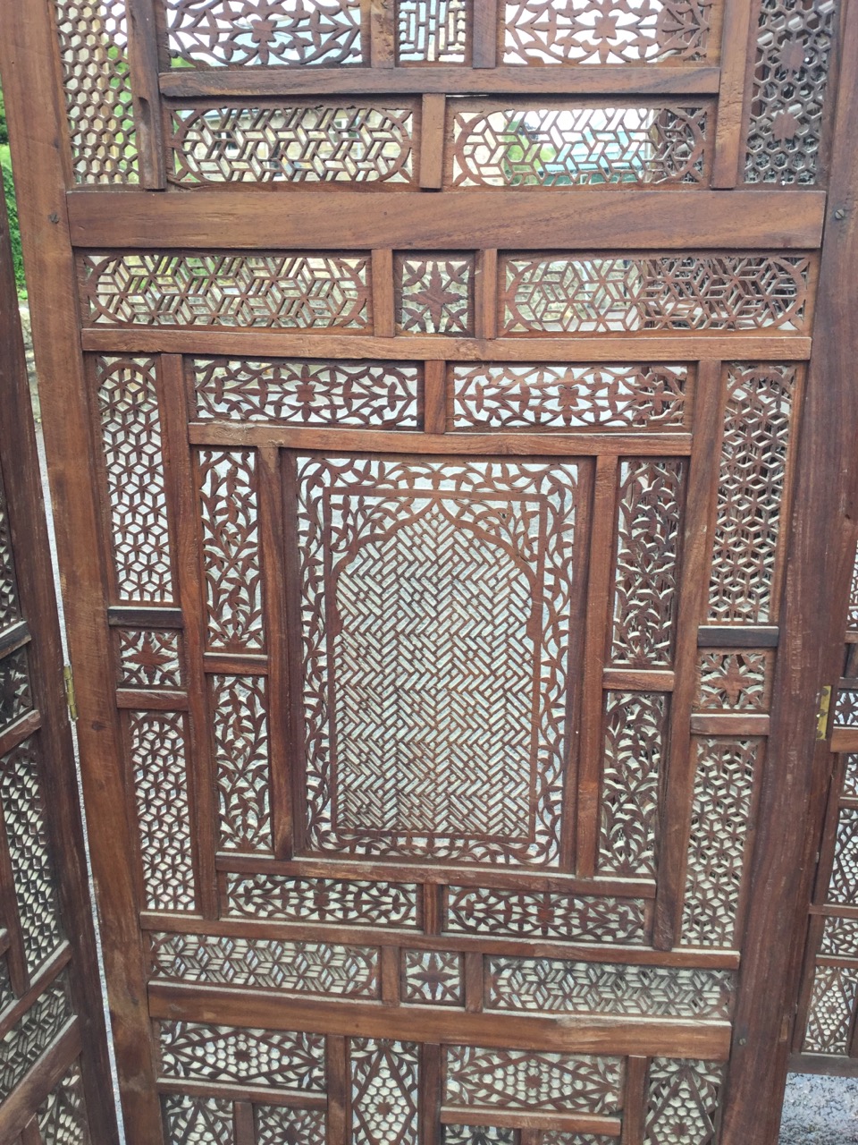 A four-fold oriental carved hardwood screen, with pierced fretwork panels in frames inlaid with - Image 2 of 3