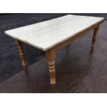 A painted pine kitchen table, the rectangular plank top on plain rails with turned legs. (72.5in x