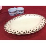 An oval creamware Herculaneum platter with basketweave type pieced rim; and a tin glazed delft