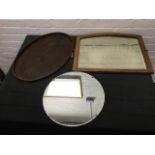 An oval stained wood tray; a circular scalloped edged framless mirror with chrome mounts; and an oak