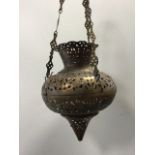 A moorish copper lamp enclosure, the pierced shade with engraved decoration hinging in two halves,