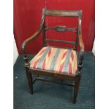 A nineteenth century mahogany elbow chair, the back with moulded tablet rail above a fluted