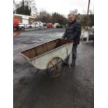 A galvanised barrow by John Wallace & Son Ltd of Glasgow, the curved riveted trough-like container