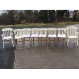 A set of eight painted slatback kitchen chairs, with squab loose cushions and solid seats, raised on