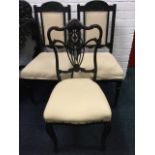 A late 19th century ebonised saloon chair with pierced scroll carved back above stuffover