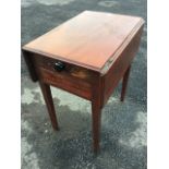 A small nineteenth century mahogany work table, the rectangular moulded top with drop leaves above