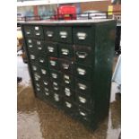 A metal cabinet containing thirty small drawers mounted with chromed label pulls. (36in x 12.25in