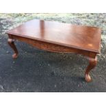 A reproduction mahogany coffee table, the rectangular crossbanded top inlaid with oval shell