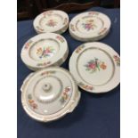 A Staffordshire H & K Tunstall part dinner service, decorated colourful floral bouquets and gilt