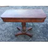 A George IV mahogany turn-over-top tea table, the rounded twin top supported on a twisted and turned