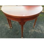 A George II style mahogany turn-over-top tea table, the D shaped twin top above a plain frieze,