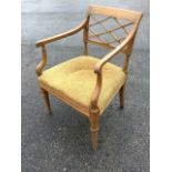 A 19th century painted armchair with trellis back, and tapering arms on octagonal shaped supports,