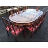 A Chinese rosewood dining room suite inlaid with mother-of-pearl blossom foliage and birds, the