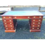 A reproduction mahogany partners desk, with inset writing surface to rectangular moulded top, the