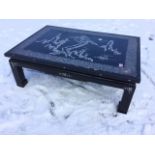 A rectangular Chinese ebonised coffee table inlaid with mother-of-pearl decoration, the panelled top