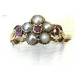 A Victorian pearl and amethyst ring designed as a flowerhead with five claw set petal pearls and