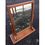 A large Victorian mahogany dressing table mirror, the rectangular chamfered frame on shaped