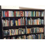 Three shelves of paperbacks - novels, travel, biographies, contemporary, classics, reference, art