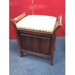 An Edwardian mahogany piano stool, with upholstered lid to box seat, the sides with angled