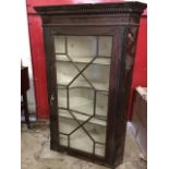 A nineteenth century mahogany corner cabinet with moulded dentil cornice above an astragal glazed