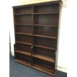 A mahogany library bookcase with moulded cornice above 12 adjustable shelves in two sections, with