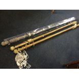A set of three brass curtain poles with fluted ball finials, complete with brass rings & cords,