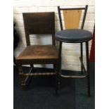 A copper studded leather upholstered oak chair raised on bobbin turned legs; and a bar style stool