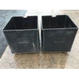 A pair of square mill bins, the riveted boxes with metal handles, each on four casters. (25in x 25in