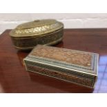An oval nineteenth century brass box embossed foliate scrolled decoration, with punched gadrooned