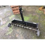 A 4ft garden lawn scarifier, the towing aerator - only once used, having spikes on axel and two