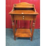 A reproduction cherrywood side table, the arched back with shelf above a rectangular rounded top and