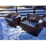 A pair of barrel garden seats, formed from oak whiskey barrels with riveted iron strap bands, the