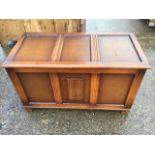 An oak blanket box with moulded panels, the front with applied linenfold decoration, raised on stile