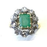 A Victorian emerald and diamond ring on gold band, the baguette cut emerald nearly 1.5 carats,