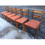 A set of six regency style mahogany dining chairs, the back rails with brass inlay above drop-in