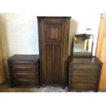 An oak Old Charm bedroom suite with dressing table, wardrobe and chest of drawers, the cabinets with