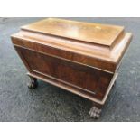 A nineteenth century mahogany cellarette of panelled sarcophagus form, the moulded cover with flat
