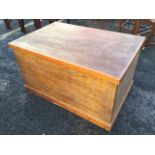 A large modern blanket box, the hinged lid with brass hinges, raised on plinth. (39.25in x 26in x