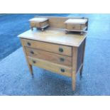 An Edwardian oak dressing chest, the rectangular moulded top with two small drawers above three long