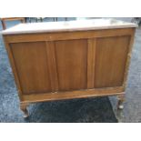 An oak blanket box with hinged lid having three panels to front, raised on stub cabriole legs. (35.