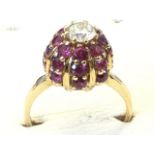 An 18ct gold ruby & diamond ring, the dome setting with rubies weighing over two-and-a-half