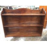 A stained pine open bookcase with shaped back & sides with three shelves. (48in x 9in x 36in)