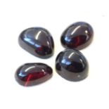 Four loose polished garnet stones of cabouchon shape, approx .5in. (4)