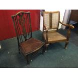 A walnut cottage chair with cane twin panelled back and shaped arms, the back rail & apron carved