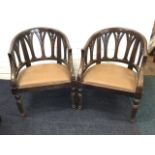A pair of captain style armchairs