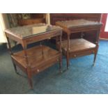 A pair of mahogany tables with plate glass tops framed by raised scalloped galleries above slides,